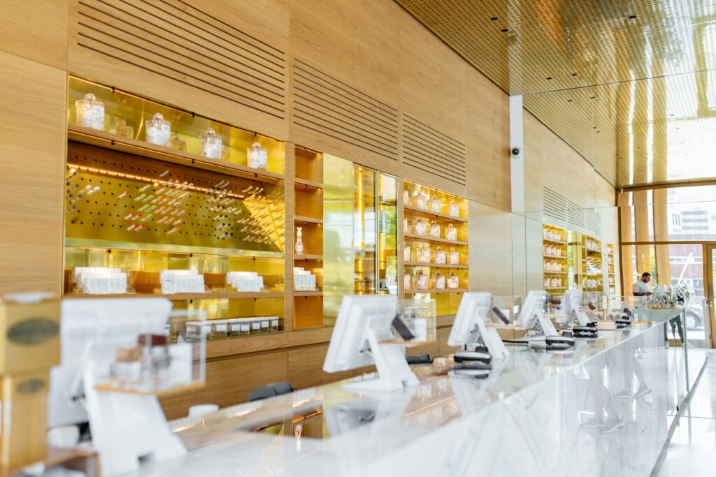 Modern CBD retail checkout counter with point of sale terminals and product displays, representing Square CBD processing rules, Shopify workarounds, and when a dedicated merchant account makes more sense