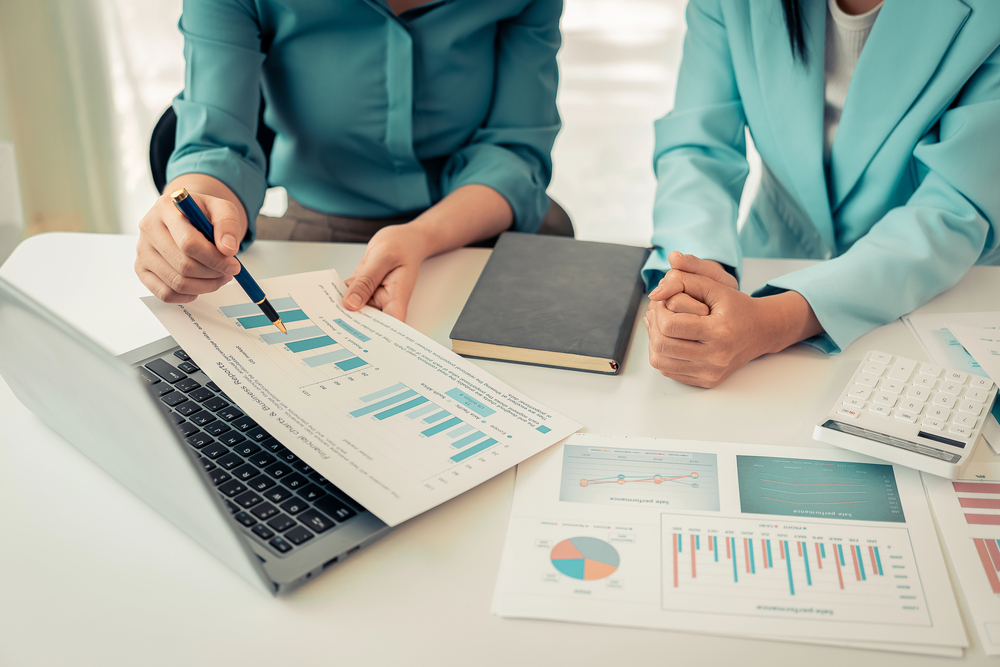 Two women monitoring high-risk merchant accounts