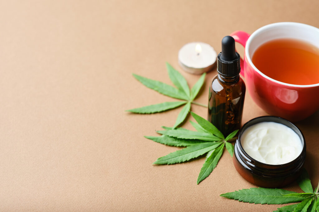 A flat lay of hemp-infused skincare products and tea for businesses working with Cannabis Payment Processing Companies.