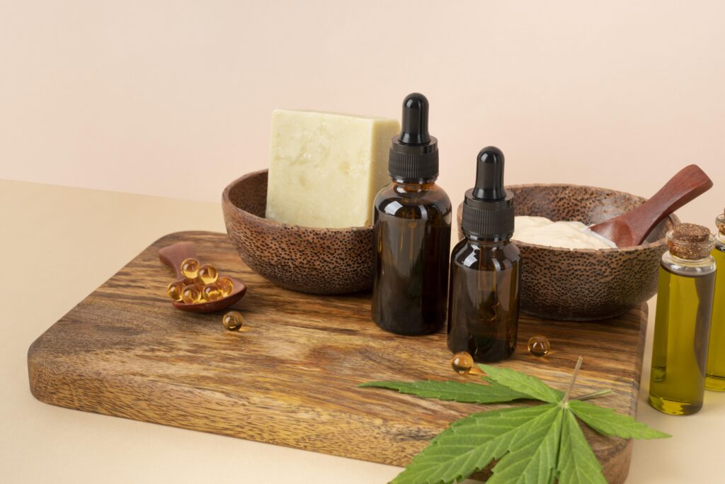 An assortment of glass CBD oil tincture bottles with droppers and fresh hemp leaves, showcasing products for a shopify CBD wellness store.