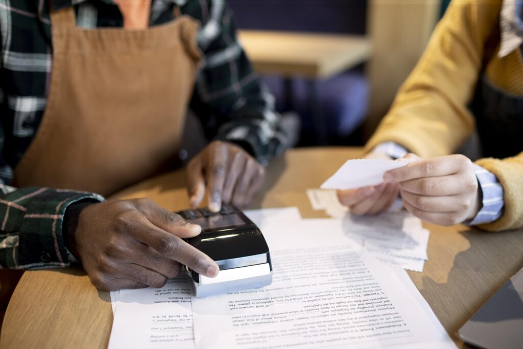A merchant processing a transaction using a payment terminal to verify the Merchant ID.