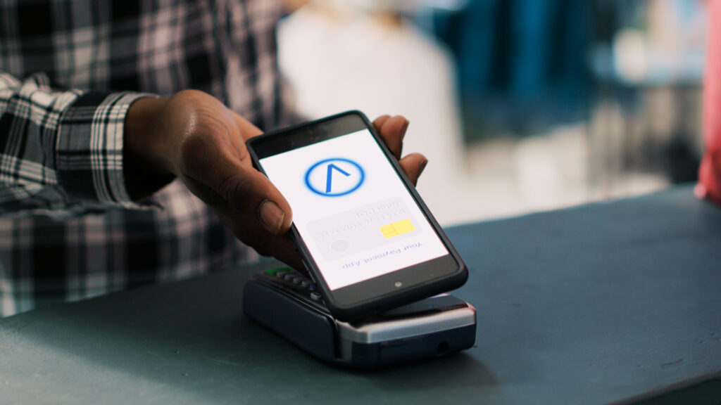 Customer using a mobile phone to process a payment with a specific Merchant ID